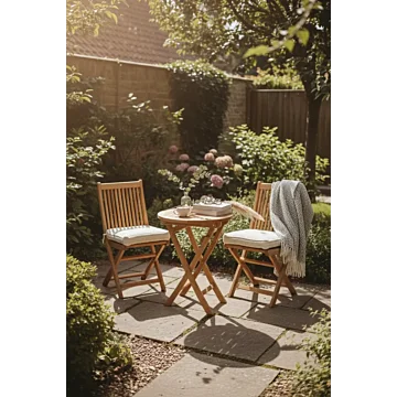 Deze bistroset creëert een intieme en rustgevende koffiehoek, perfect voor kleine terrassen of een zonnige plek in de achtertuin. De combinatie van warm teakhout en zachte texturen straalt een tijdloze, landelijke elegantie uit die uitnodigt tot lange och